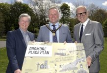 Three men hold a sign to promote the launch of the Dromore Place Plan.