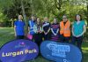 Group of people standing behind signs to promote the new Lurgan Park Parkrun and Get Moving ABC.