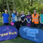 Group of people standing behind signs to promote the new Lurgan Park Parkrun and Get Moving ABC.