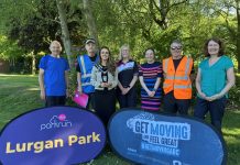 Group of people standing behind signs to promote the new Lurgan Park Parkrun and Get Moving ABC.