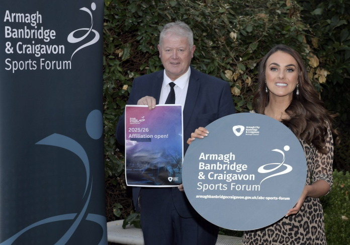 Affiliation open! A male and a female are holding signs to promote the ABC Sports Forum.