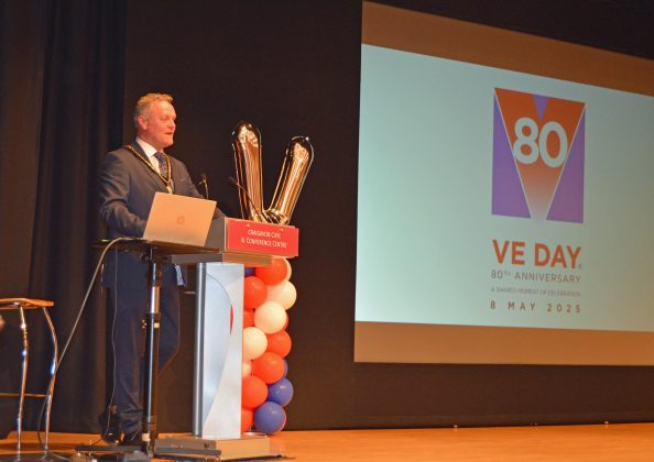 Man at lectern.
