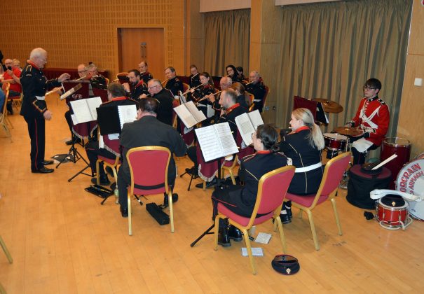 Musical band seated inside.
