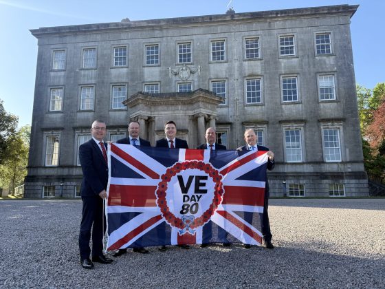 Men holding a flag outside.