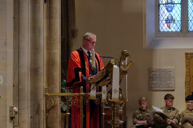 One man standing at lectern.