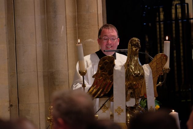 Man at lectern.