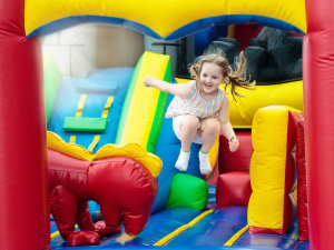 Young child bouncing on a giant inflatable