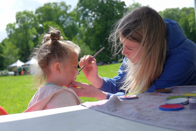 Young girl getting her face painted