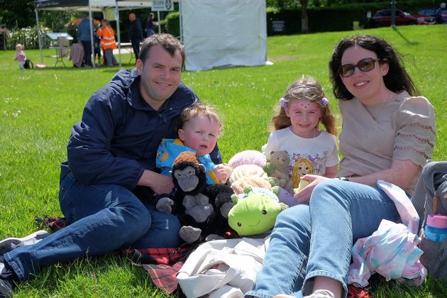 Family of four on picnic blanket