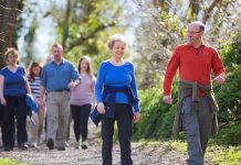 A small group of adults walking through the countryside.