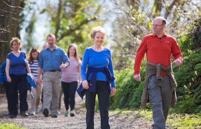 WFA A small group of adults walking through the countryside.