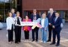 A group of people standing outside a building holding a sign that says Armagh City, Banbridge and Craigavon Labour Market Partnership.