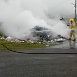 Members of the NI Fire and Rescue Service tackle a fire which broke out among rubbish in an ABC Council bin lorry.