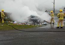 Members of the NI Fire and Rescue Service tackle a fire which broke out among rubbish in an ABC Council bin lorry.