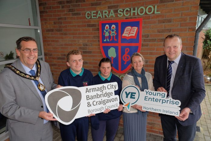 Young Enterprise NI A group of people standing outside Ceara School holding ABC Council logo and Young Enterprise NI logo.