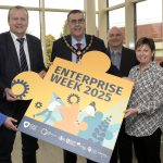 People standing holding a sign which reads Enterprise Week 2025.