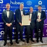 Banbridge Public Realm project celebrated with prestigious construction award Four men standing at an awards ceremony with a framed certificate, with one man holding a crystal award.