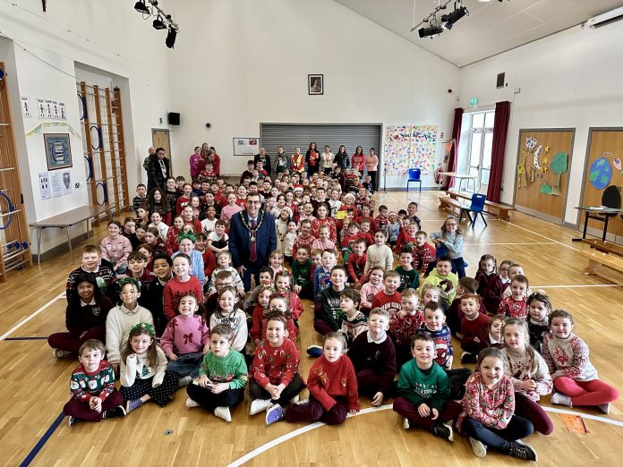 20251205_104307132_iOS Lord Mayor sitting among the pupils and staff of St Teresa's Primary School, Lurgan