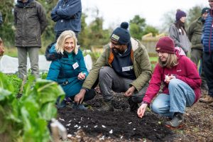 Biruk Sahle and  community gardeners planting garlic in the Natural World Products 'No-Dig' Garden