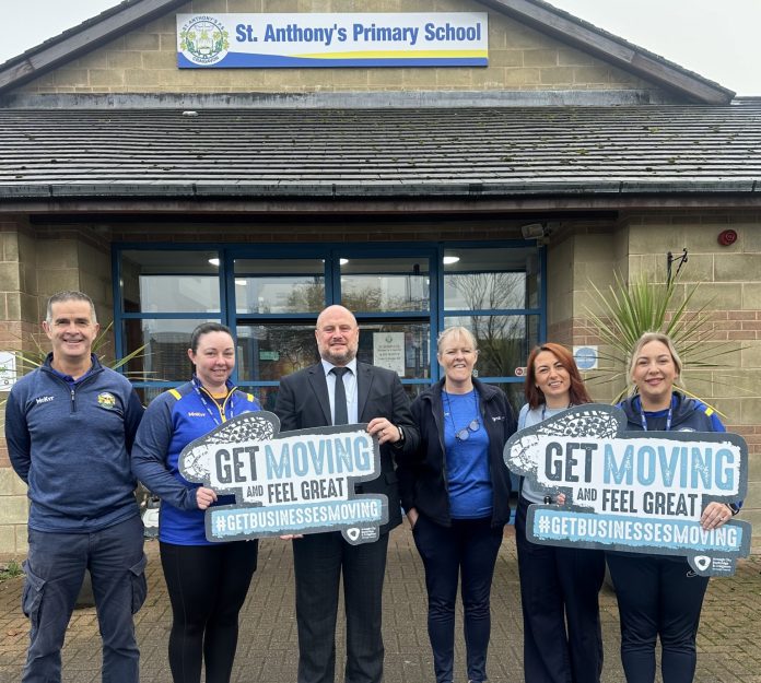 St.Anthonys 1 Six staff from St Anthony's Primary School standing outside the school holding signs to promote the council's Get Moving programme.