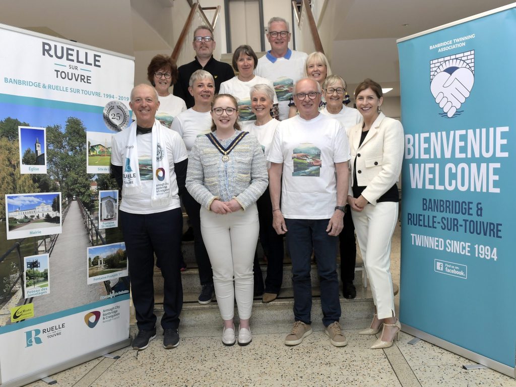 A large group of people together in Banbridge to welcome French visitors.