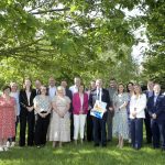 ABC Local Economic Partnership launches action plan to drive economic growth across borough Large group of people standing in a wooded area with a Department for Economy banner.