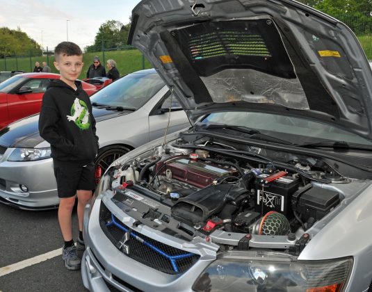 Logan Quinn from Portadown admires the engine in this Mitsubishi Evo Nine Wagon, which is the only one in Northern Ireland.