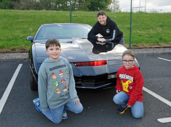 Elliot, 9 yrs and Theodore, 6 yrs and their father David Abraham with their Pontiac Firebird Trans Am made famous as Kitt in the 1980s TV show, Knight Rider.