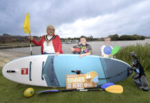 Soak up the summer fun with getactiveabc! the lord mayor and 2 children standing beside a lake with a paddleboard and sports raquets.