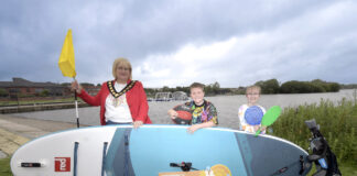 Soak up the summer fun with getactiveabc! the lord mayor and 2 children standing beside a lake with a paddleboard and sports raquets.
