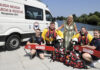 two rescue crew members and two swimming instructors are pictured with the lord mayor beside the Lough Neagh Search and Rescue van.