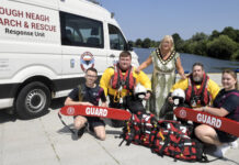 two rescue crew members and two swimming instructors are pictured with the lord mayor beside the Lough Neagh Search and Rescue van.