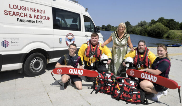 NEWS two rescue crew members and two swimming instructors are pictured with the lord mayor beside the Lough Neagh Search and Rescue van.