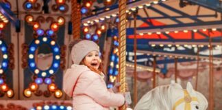 Applications open for funfair suppliers for Georgian Festival Weekend Young girl sitting on a merry go round horse