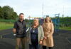 3 people standing in front of play equipment in a playpark.