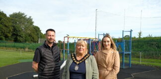 Contractor appointed for £2.3million upgrade of playparks 3 people standing in front of play equipment in a playpark.