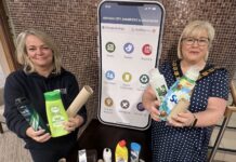 Two females holding household waste items which can be recycled