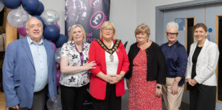 6 people stand together at the funding celebration event.
