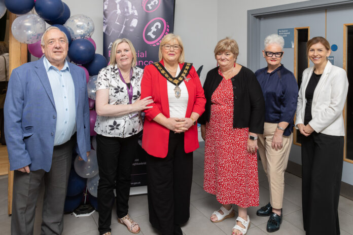 6 people stand together at the funding celebration event.